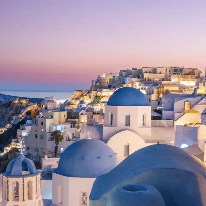 The iconic blue and white domes of Santorini Greece.